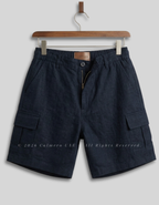 Dark navy blue cargo shorts with an elastic waistband, hanging on a wooden hanger against a light gray background.